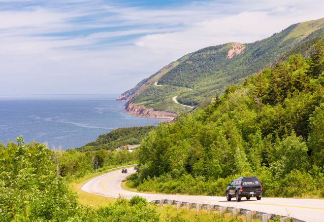 You can travel to Cape Breton by car via the Canso Causeway, by ferry from Newfoundland, or by air to Sydney airport